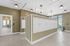 Stylishly designed mailroom with beige and white geometric wallpaper, featuring modern lighting and mailboxes.