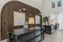Elegant reception area with stylish wooden paneling, modern desks, and warm lighting.