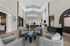 Luxurious open-concept living room with high ceilings, modern furniture, and elegant lighting.