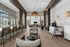 Spacious lounge with modern seating, high ceilings, and stylish pendant lighting.