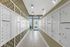 Elegant mailroom featuring organized rows of mailboxes with geometric patterned walls.