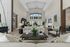 Luxurious lounge area with high ceilings, stylish furniture, and large windows providing natural light.
