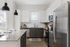 Stylish kitchen with sleek cabinetry, stainless steel appliances, and a spacious granite countertop island.