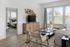 Stylish living room with modern furniture, wooden accents, and large windows with natural light.
