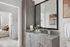 Modern bathroom with a sleek vanity, large mirror, and view into a cozy bedroom.