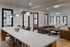 Stylish open-concept living space with a modern dining area, chic pendant lighting, and cozy seating.