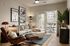 Stylish living room with contemporary decor, large sofa, art pieces, and a view of the balcony.