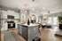 Modern open-concept kitchen with a stylish island and a cozy living area with natural light and elegant decor.