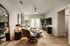 Chic living room with modern furniture, wooden flooring, large TV, and decor accents.