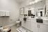 Luxurious bathroom featuring dual sinks, modern decor, and elegant lighting.