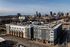Modern urban apartment complex with skyline views and convenient city access.