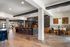 Elegant open-concept living area with sleek bar seating, sophisticated dining nook, and modern finishes, perfect for entertaining.
