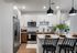 Modern kitchen with sleek cabinetry, stainless steel appliances, and a stylish breakfast bar with elegant pendant lighting.