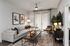 Chic and modern living room featuring a spacious grey sofa, abstract wall art, and a stylish coffee table in a bright, inviting space with ample natural light.