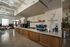 Chic industrial-style coffee shop interior with sleek espresso machine and inviting seating area.