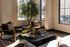 Bright and inviting living room with modern chairs, a stylish coffee table, and lush greenery, bathed in natural sunlight from large windows.