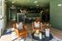 Inviting lobby area with luxurious leather chairs, stylish green brick walls, and modern decor, exuding warmth and sophistication.