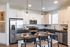 Sleek modern kitchen with stainless steel appliances, elegant pendant lighting, and a chic island perfect for entertaining.