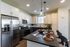 Modern kitchen with sleek stainless steel appliances, elegant pendant lighting, and a stylish island with bar seating.