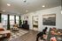 Inviting living room with modern decor, cozy seating, natural light, and stylish artwork, seamlessly connected to the dining area with elegant table settings.