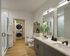 Modern bathroom with sleek dual sinks, elegant mirrors, and in-unit washer and dryer set.
