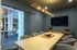 Sophisticated conference room featuring modern decor, a sleek table, and stylish lighting, perfect for productive meetings.