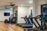 Modern fitness center featuring state-of-the-art treadmills and exercise equipment with sleek wooden flooring, ideal for staying active.