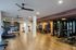Spacious and modern gym with state-of-the-art fitness equipment, stylish decor, and ample natural lighting.