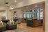 Elegant open-concept living area showcasing a modern kitchen with sleek cabinetry, stylish dining space, and cozy seating with contemporary lighting.
