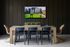 Modern dining area with a sleek wooden table, stylish blue and wicker chairs, and wall-mounted TV for vibrant entertainment.