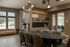 Elegant communal space featuring stylish mid-century modern furnishings with natural wood accents, large windows, and a chic art piece.
