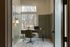 Cozy home office with serene forest views, featuring a stylish wooden desk and a comfortable chair, perfect for productivity and inspiration.