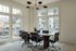 Bright, modern conference room with large windows, sleek furnishings, and stylish lighting, offering a professional and inviting atmosphere.