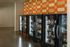 Contemporary snack area featuring brightly lit vending machines against a stylish orange checkered wall.
