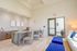 Elegant lobby area featuring a modern reception desk, stylish chairs, and plush seating with decorative wall art and soft lighting.