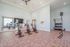 Spacious and modern gym with exercise bikes, vibrant equipment, and a large mirror, ideal for a dynamic workout experience.
