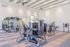 Modern fitness center with state-of-the-art exercise equipment and spacious interior, perfect for energizing workouts.
