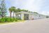 Inviting car wash facility surrounded by lush palm trees, offering convenience and scenic views for residents.