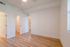 Bright, airy room with elegant wood flooring, ample closet space, and a modern ceiling fan, perfect for a cozy retreat.