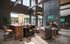 Luxurious modern living room with high ceilings, elegant fireplace, chic furniture, and natural light streaming through large windows.
