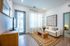 Chic and inviting living room featuring modern d&eacute;cor, a cozy white sofa, artistic wall art, and a wooden coffee table on a stylish rug.