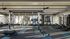 Modern fitness center featuring state-of-the-art gym equipment, bright windows, and ample space for workouts.
