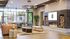 Sophisticated living area with modern fireplace, plush seating, and large windows offering garden views.