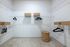 Spacious walk-in closet with elegant shelving, woven baskets, and plush carpet flooring.