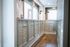 Chic apartment mailroom featuring sleek mailboxes, modern lighting, and stylish wood flooring.