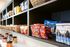 Modern pantry shelf with a variety of colorful snacks organized in stylish baskets and jars.