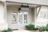 Charming entrance to Livano with elegant glass door and lush landscaping, welcoming you to a sophisticated space.