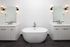 Luxurious bathroom featuring a sleek freestanding tub, dual vanities, and modern lighting fixtures.