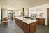 Chic and inviting cafe space featuring modern wooden furnishings, sleek countertops, and abundant natural light.