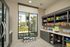 Modern convenience store corner with floor-to-ceiling windows, offering a bright and inviting atmosphere with a wide selection of snacks displayed on stylish shelves.